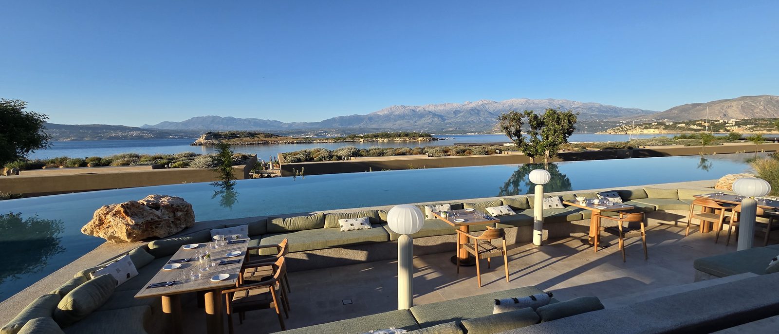 A pool terrace above the water in the late afternoon