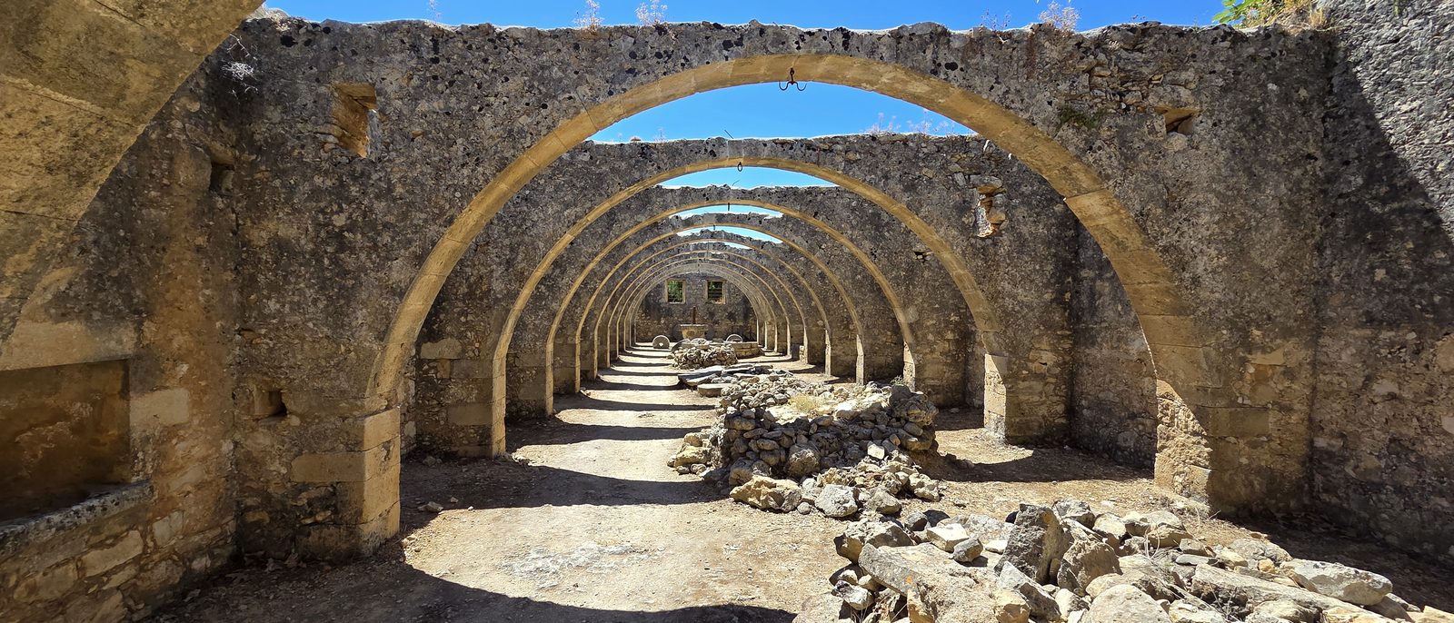 Stone arches on a terrace, late in the afternoon